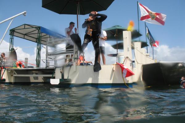 A Maritime Archaeology student jumps off the old Dive Platform 