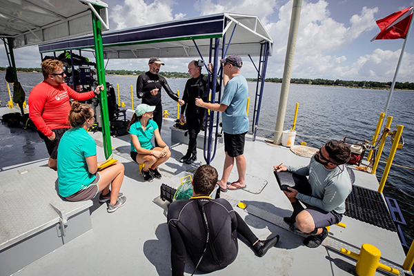 Several Students and Faculty Members gather for discussion on the MSC Dive Platform