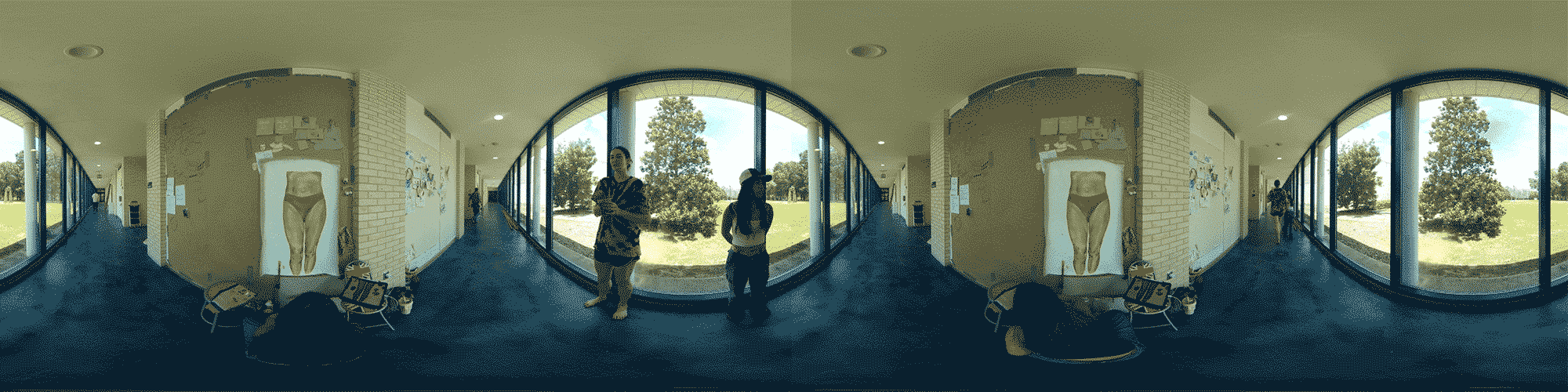 Moving panorama of students in the art wing of the CFPA, viewing art on the wall and drawing