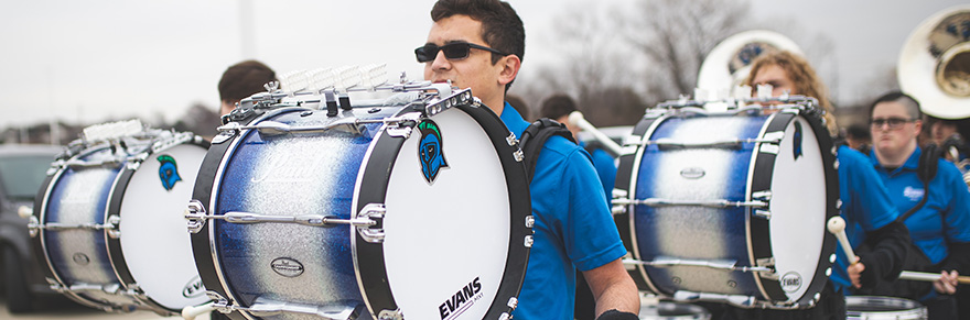 A student plays the drum.