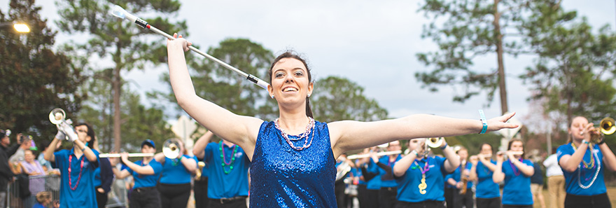 Majorette leading the Argo Marching Band during a parade.