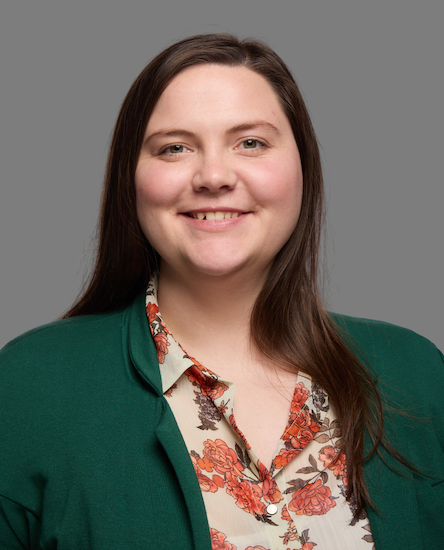 Theatre faculty member wearing a suit jacket and blouse.
