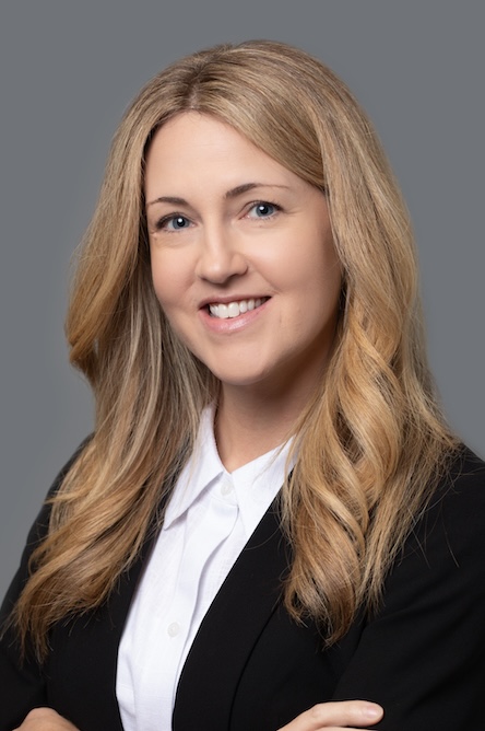 Headshot of college faculty member with long hair, wearing a suit.