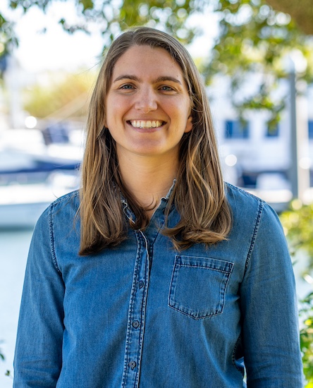 Rachel Hines in a blue shirt under a tree.