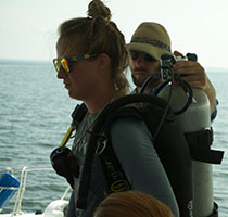 Students on diving platform preparing scuba gear