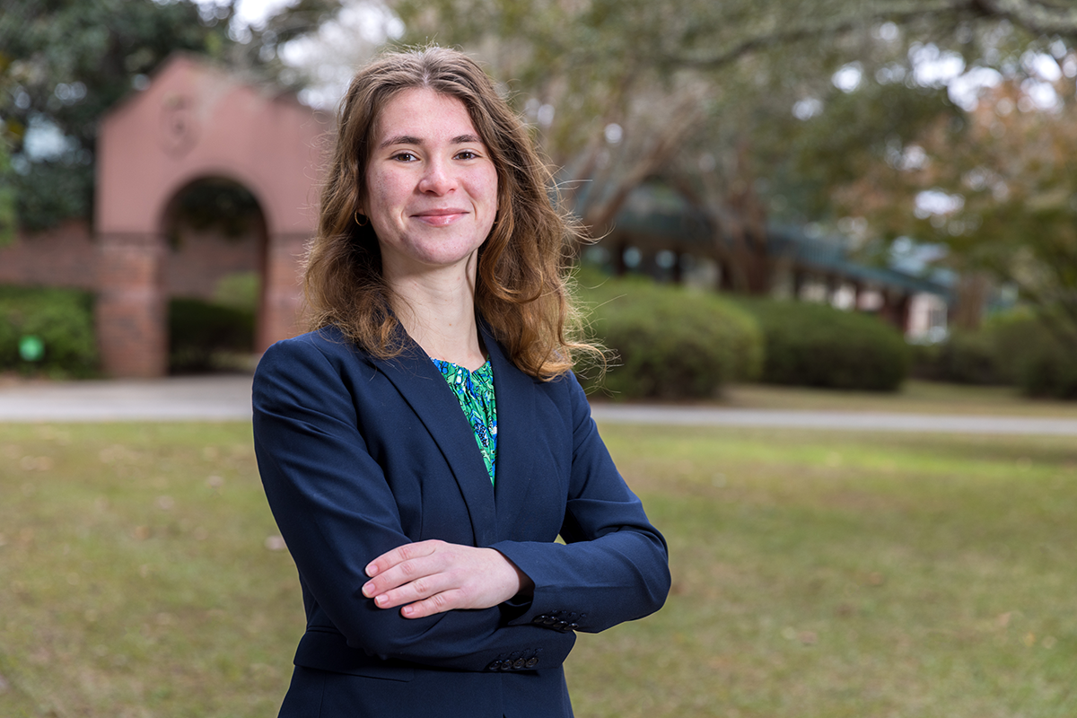 Student in blazer crossing their arms