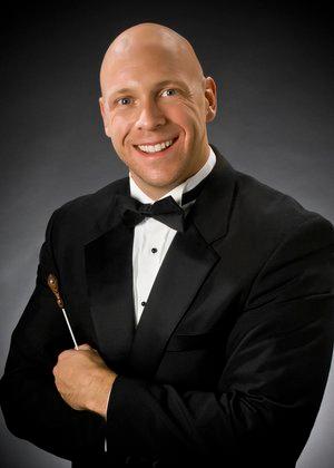 A man in a formal black suit.
