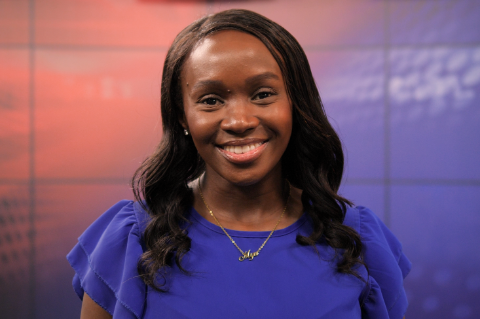 A headshot of an alumna in a blue blouse