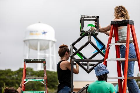 Students and instructors building a scupture