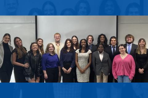 A group of professionally dressed students stand together