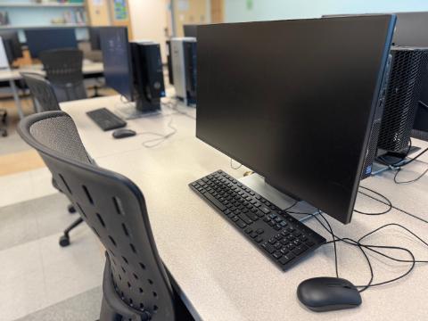 A computer and chair in the Multiplatform Lab, building 4, Pensacola campus.