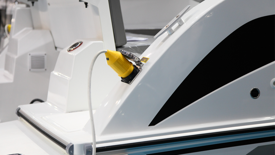 close up of the back of a boat with an electric plug in the boat.