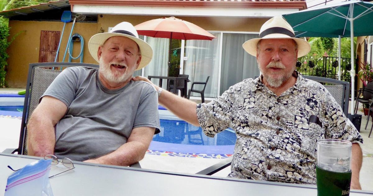 Two gentlemen next to a pool