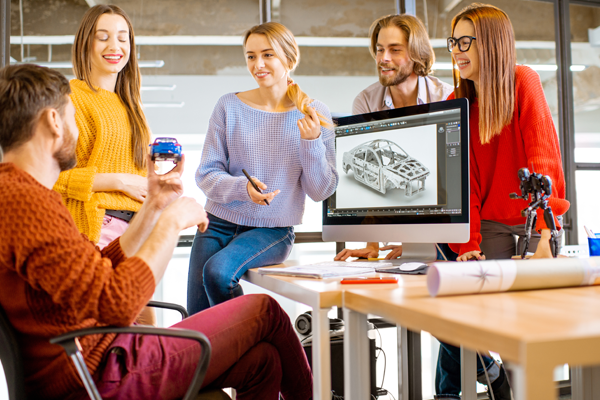 students standing around a computer with 3-D modeling shown