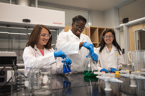 Three students in chemistry lab