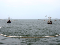 Shrimp boats tow fire-resistant oil-containment boom in Gulf of Mexico 2010-05-03