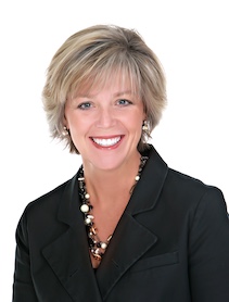Headshot of woman with short blond hair dressed in black shirt.