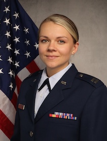 Headshot of Amanda Eckel in front of the U.S. flag.