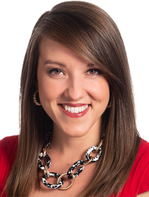 Headshot wearing red shirt and chain-linked necklace