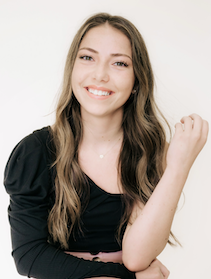 Headshot of woman with long brown hair wearing a black shirt.