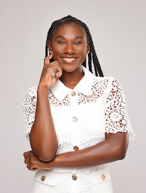 Headshot of woman with braided black hair wearing a white shirt.