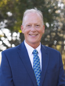 Headshot of man in blue suit