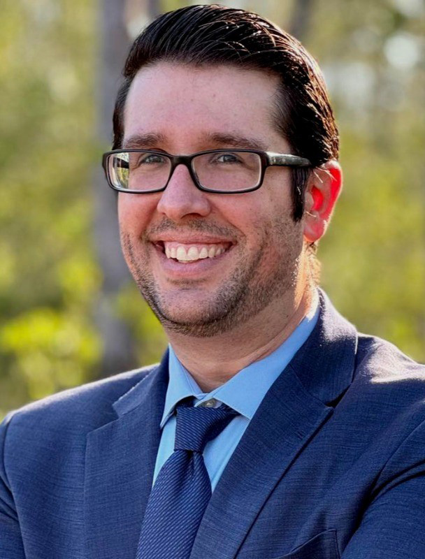 Headshot of man in blue suit