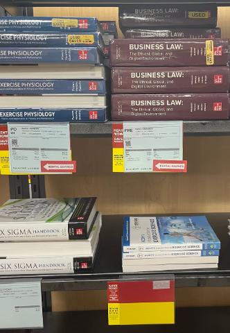 Textbooks on a bookshelf in the UWF Bookstore