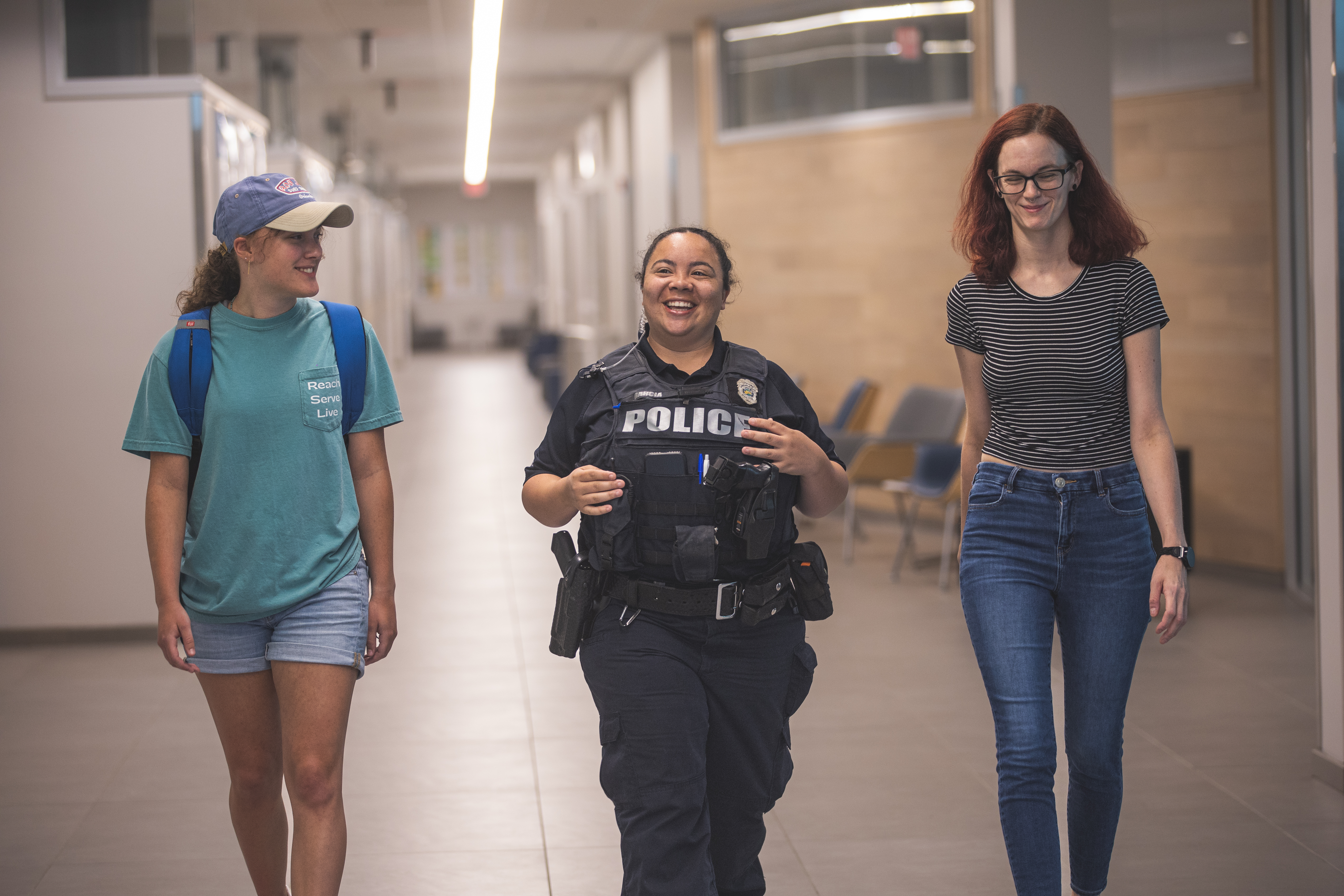 Students with Officer in Hallway