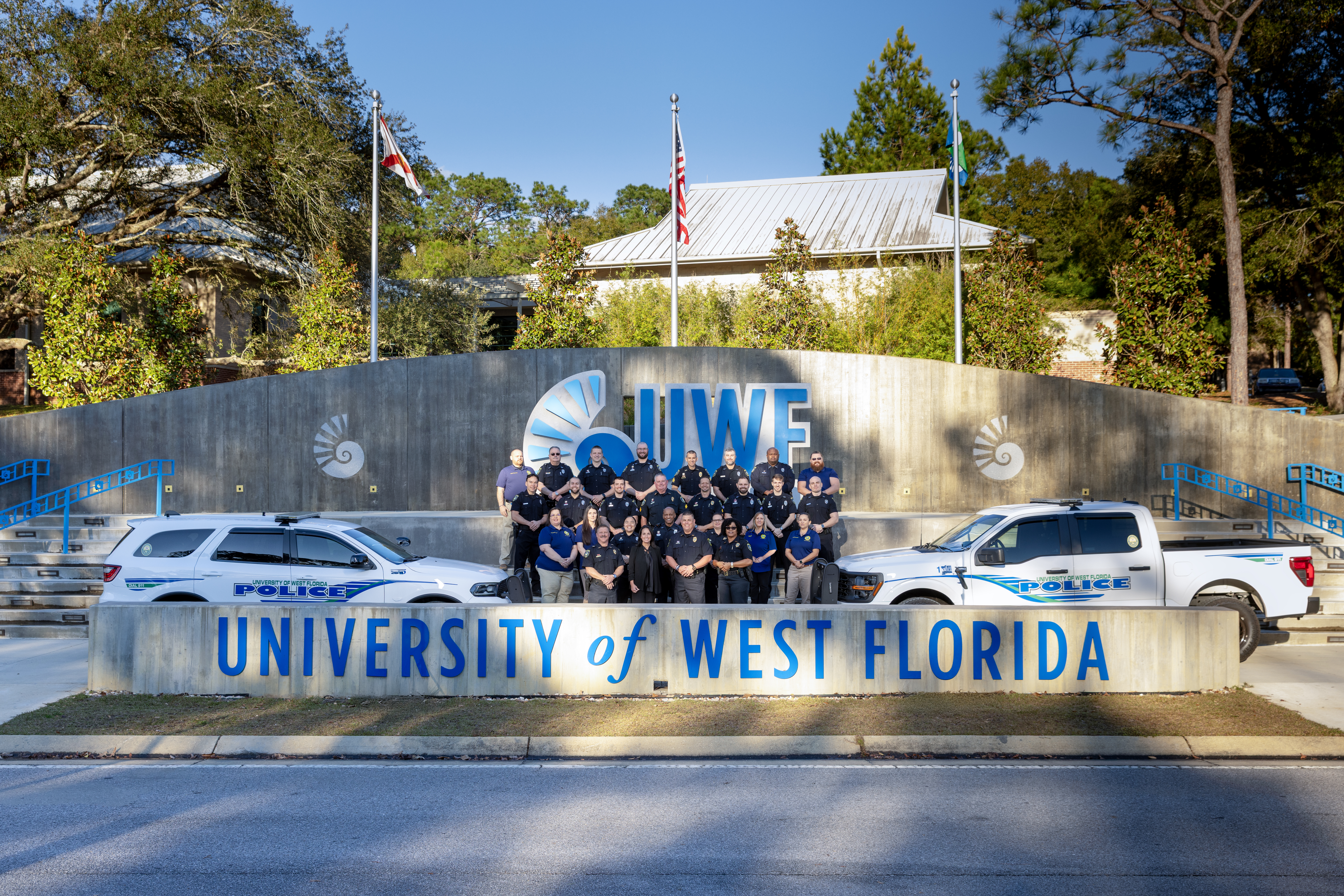 UWF Police Department group photo in front of UWF entrance