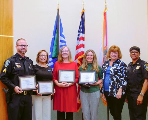 six uwf staff members, four posing with distinguished service awards
