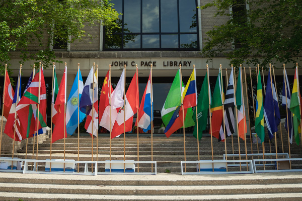 International flags in front of the Pace Library building exterior