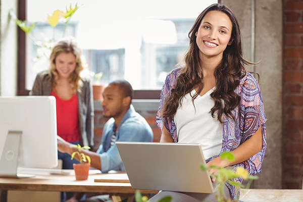 Creative with laptop smiling in office
