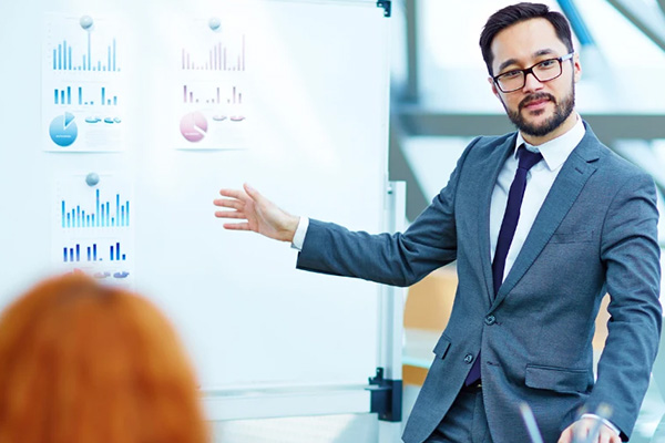 Employee presenting data on board in a conference room meeting
