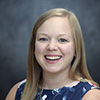 Kara Dingess smiling for an indoor headshot.