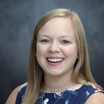 Kara Dingess smiling for an indoor headshot.