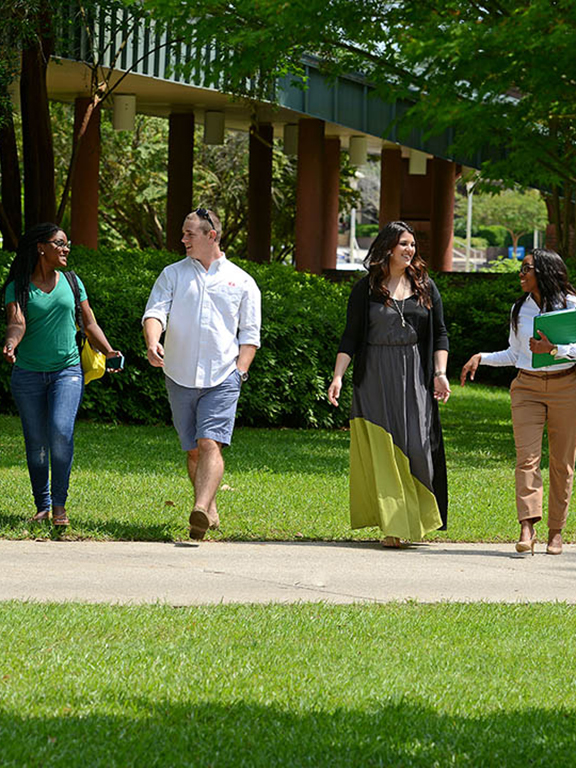 Students walk across the main campus in Pensacola.