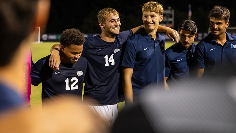 Argo teammates smiling on the soccer field