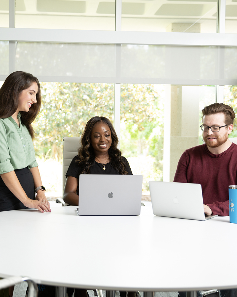 Students working together looking at a laptop computer