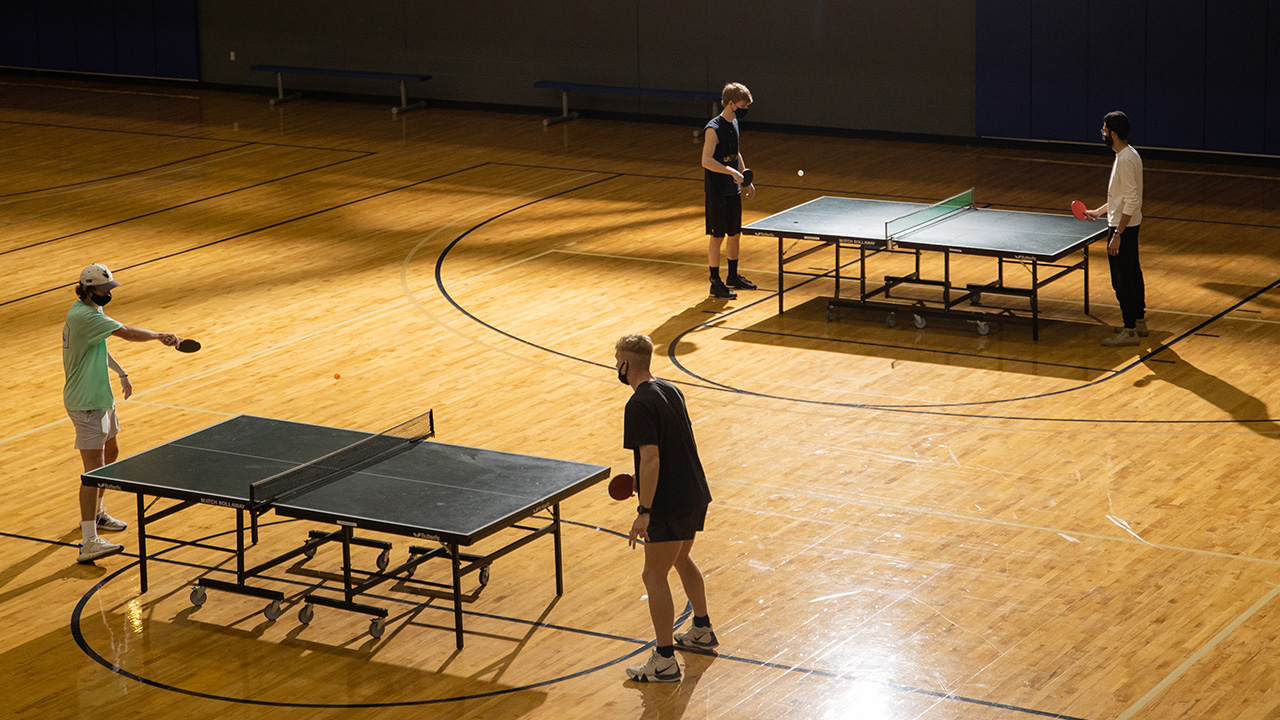 People playing Ping Pong in the gym