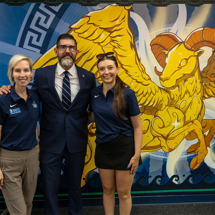 Interim President, BOT President and SGA President posing in front of mural