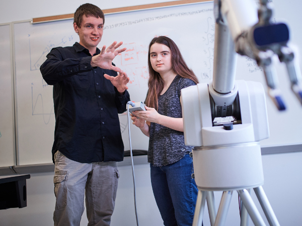 National Merit Finalist, Diana Hanks, is shown a robotic arm in Building 4 of University of West Florida's campus.
