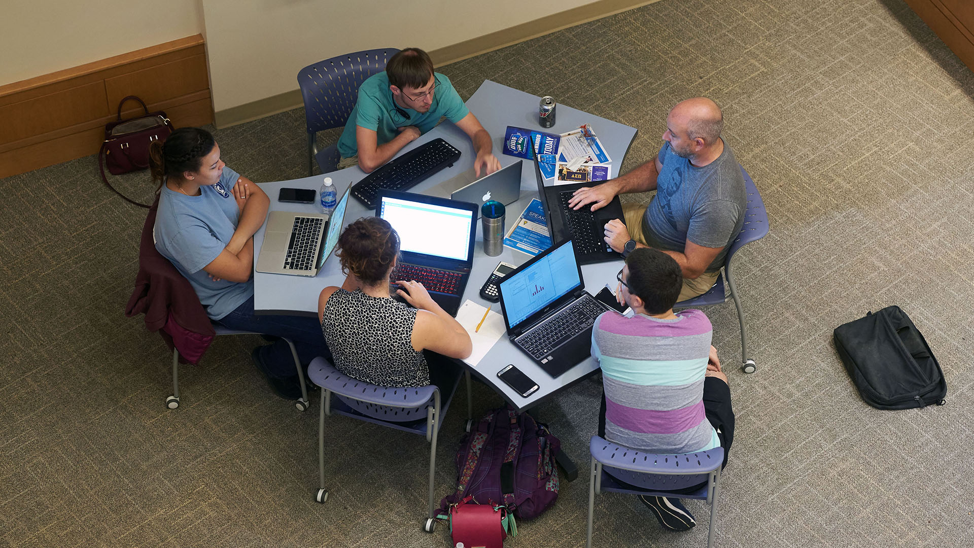 Students using computers that were probably checked out at the library.