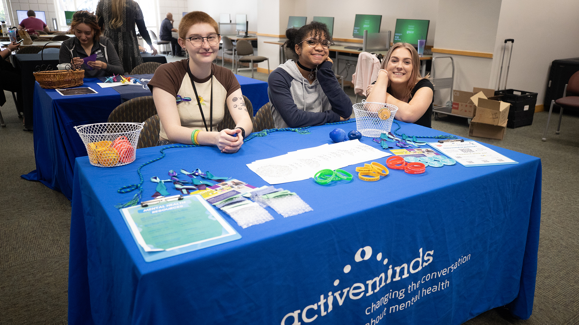 Students sitting at an exhibit table.