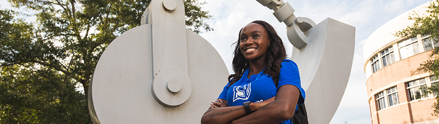 UWF student in front of Building 4