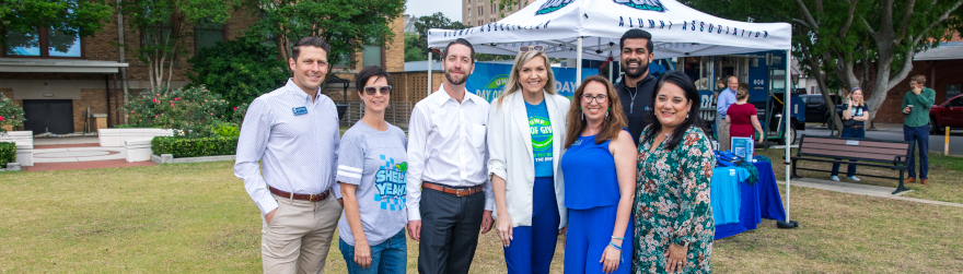 A group of alumni pose together at the 2024 Founders Week Alumni Breakfast on Museum Plaza