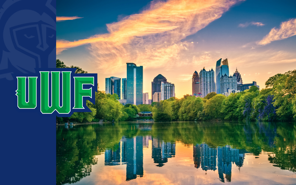 Atlanta skyline reflected in a lake at sunset, with trees in the foreground and a UWF logo on the left.