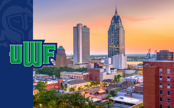 Downtown Mobile skyline at sunset with city buildings and streets viewed from above, with a UWF logo on the left.