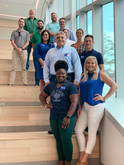 The Alumni Board of Directors stand as a group on the stairs of the new Lab Annex building.