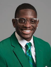 Chris Baptiste smiles in his green Ambassadors jacket.